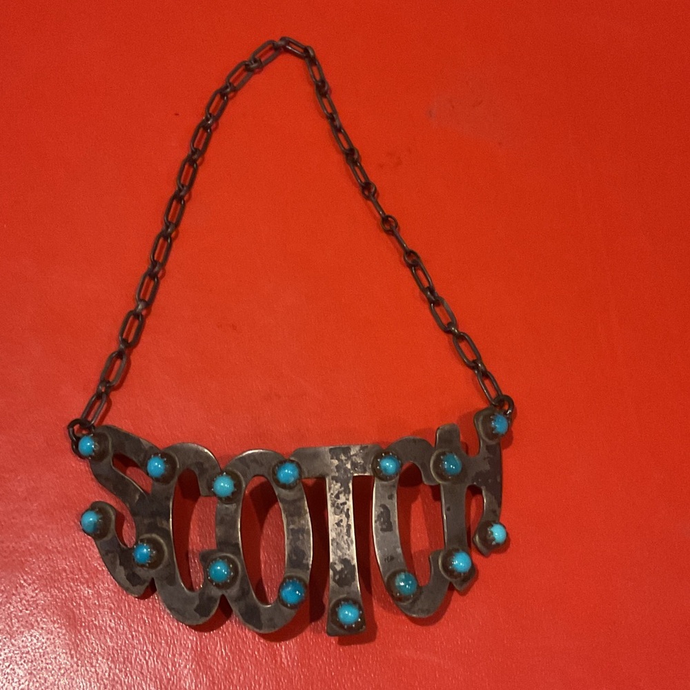 Turquoise liquor bottle necklace.